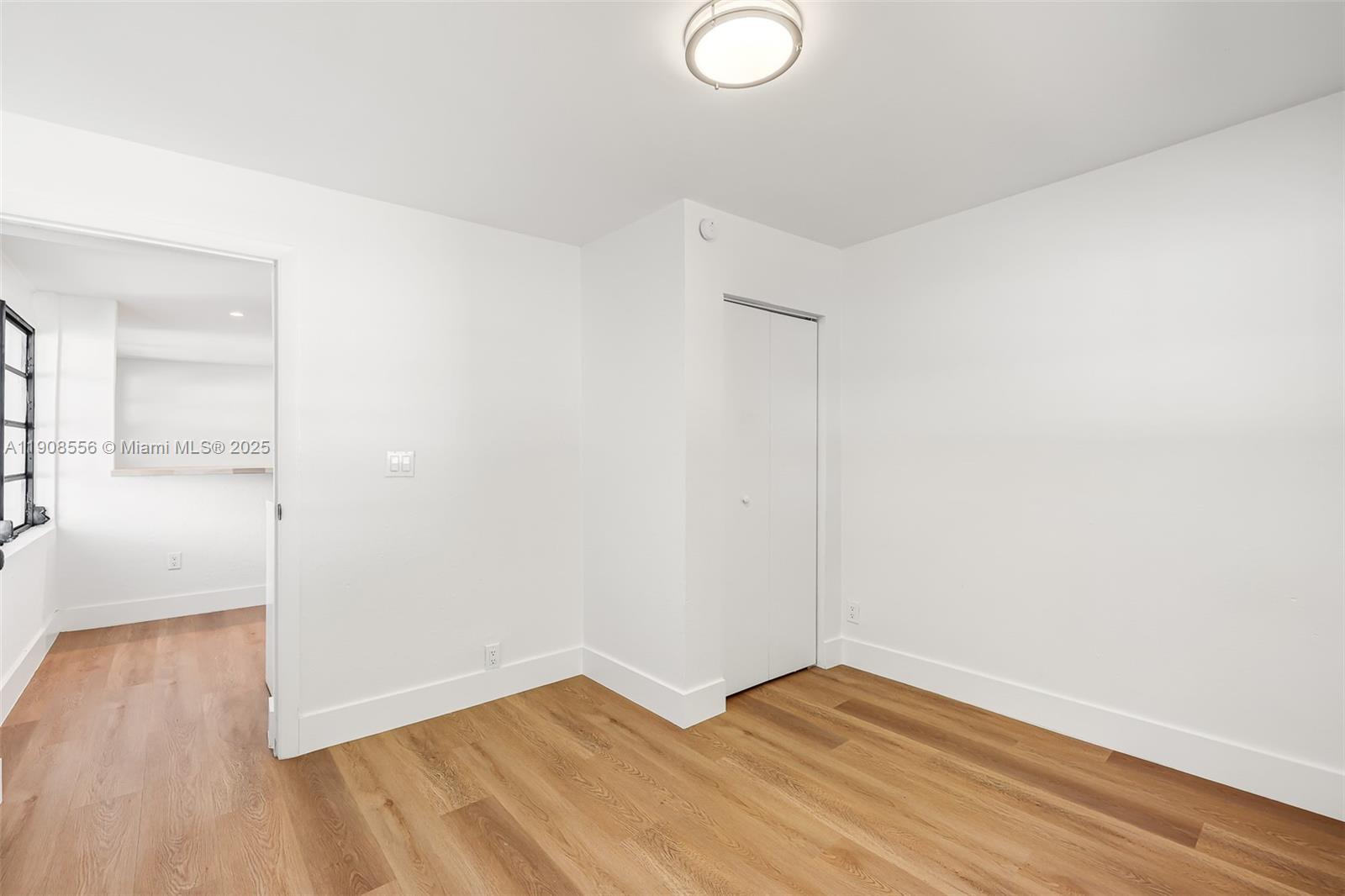 Grapeland Heights Estates Miami, FL 33125 - Photo 19 of 26 a view of empty room with wooden floor