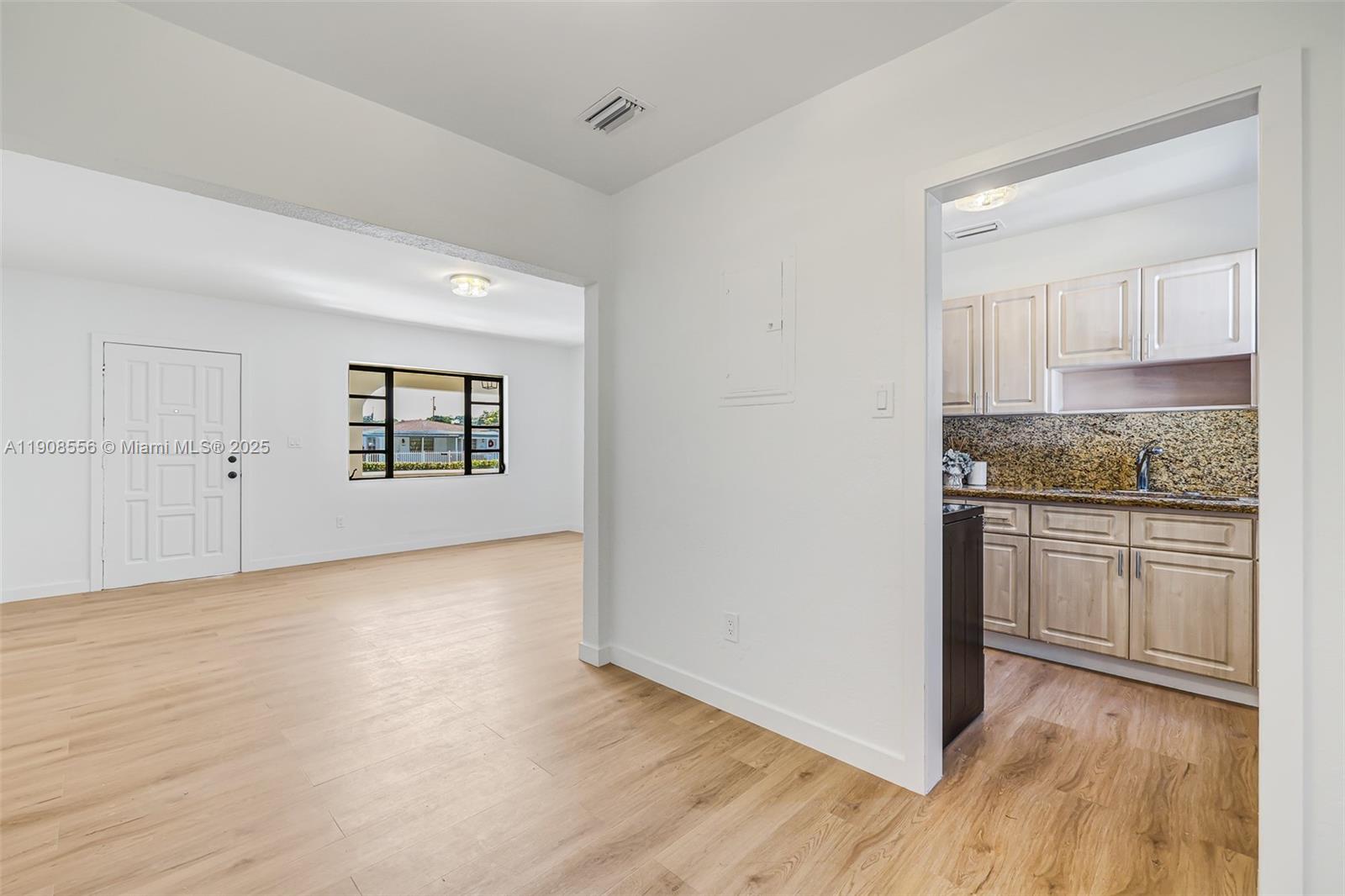 Grapeland Heights Estates Miami, FL 33125 - Photo 26 of 26 an empty room with kitchen appliances and cabinets