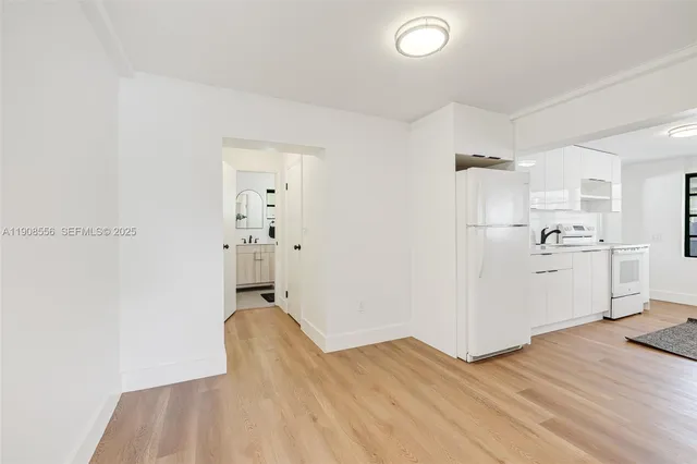 a view of a kitchen with wooden floor