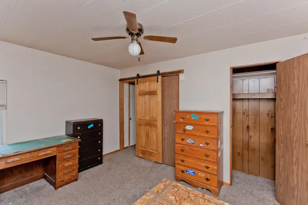 a view of room with window and a ceiling fan