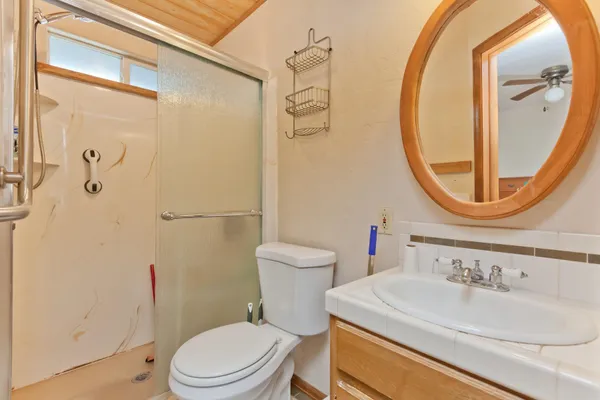a bathroom with a sink a toilet and a mirror