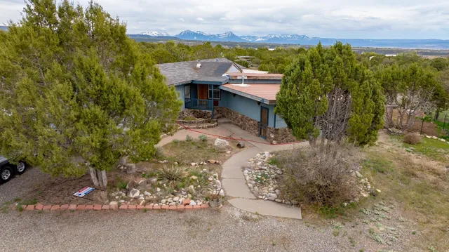 an aerial view of a house with a lake