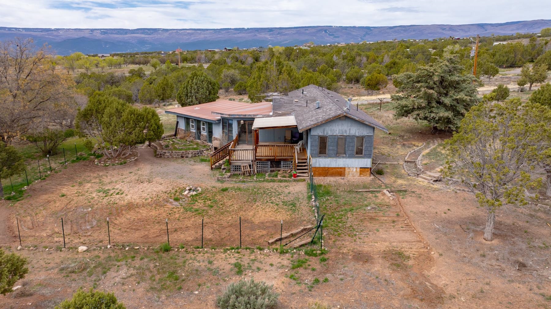 25352 Cedar Mesa Road Cedaredge, CO 81413 - Photo 34 of 42 a view of a house with a yard