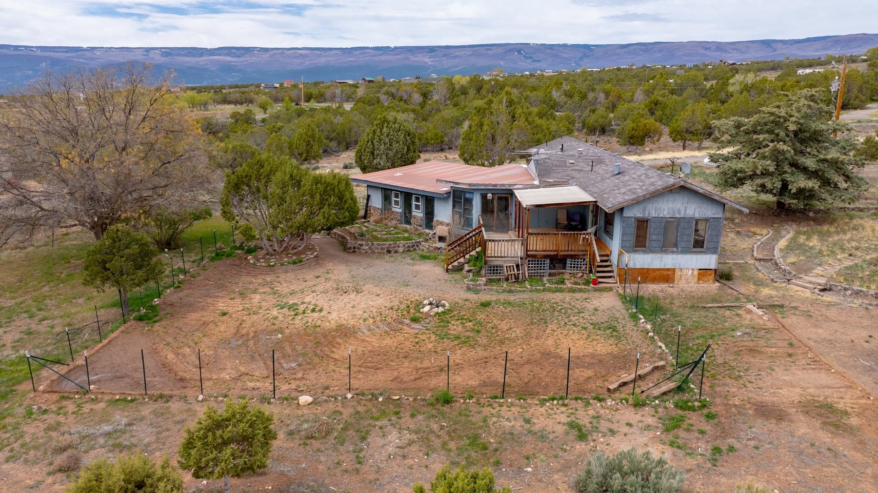 25352 Cedar Mesa Road Cedaredge, CO 81413 - Photo 40 of 42 a view of a house with a garden