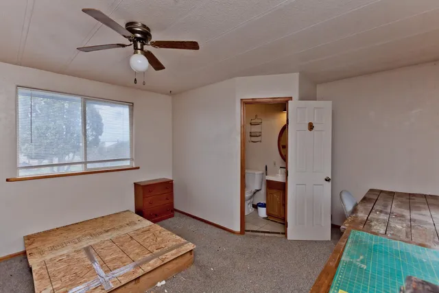 a bedroom with a bed and a dresser