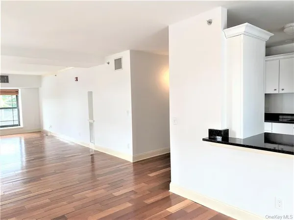 a view of a kitchen with wooden floor and electronic appliances