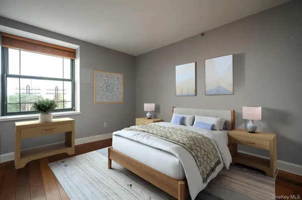 a bedroom with a bed and a large window