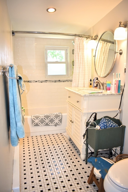 12 Searle Road, Unit 12 Boston, MA 02132 - Photo 7 of 35 a bathroom with a sink a toilet and a mirror