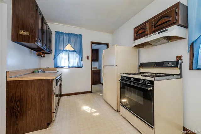 a kitchen with a refrigerator and a stove