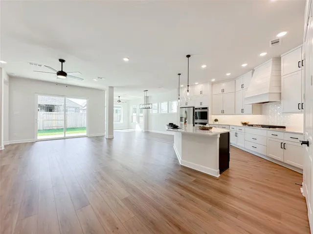 a view of kitchen with cabinets and wooden floor