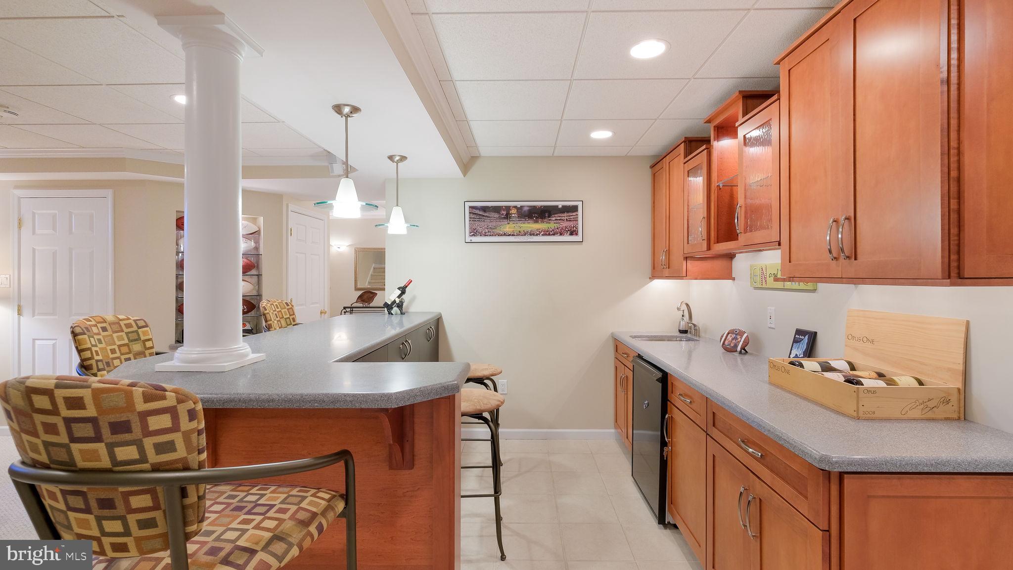 33 Bittersweet Drive Doylestown, PA 18901 - Photo 55 of 71 a kitchen with stainless steel appliances kitchen island granite countertop a table chairs in it and wooden floors