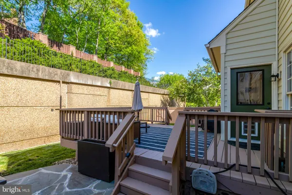 a view of a roof deck with wooden floor and fence
