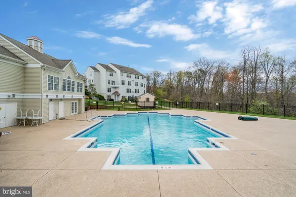 a view of yard with swimming pool and seating