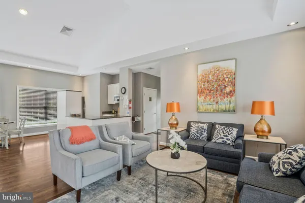 a living room with furniture and wooden floor