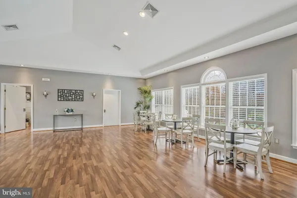 a view of a livingroom with furniture wooden floor and a window