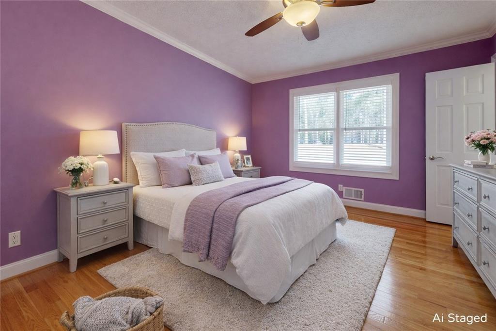 1319 Janmar Road Snellville, GA 30078 - Photo 11 of 38 a bedroom with a bed and a chandelier