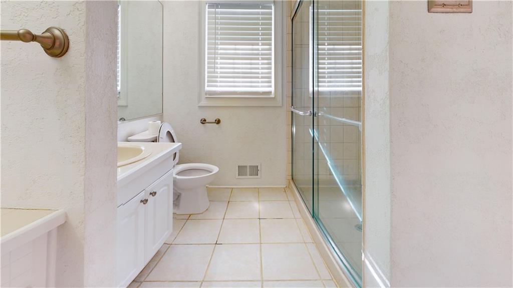 1319 Janmar Road Snellville, GA 30078 - Photo 20 of 38 a bathroom with a toilet and a shower