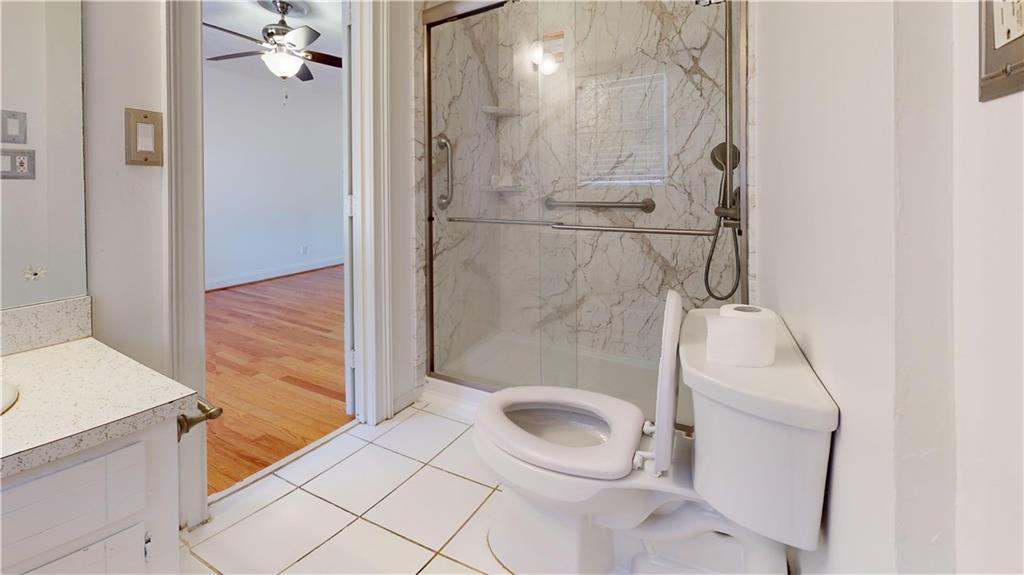 1319 Janmar Road Snellville, GA 30078 - Photo 21 of 38 a bathroom with a granite countertop shower and a sink