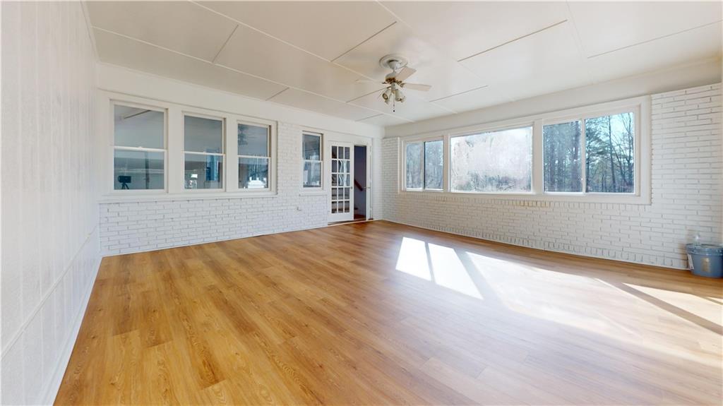 1319 Janmar Road Snellville, GA 30078 - Photo 23 of 38 a view of an empty room with wooden floor and a window