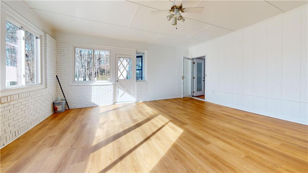 1319 Janmar Road Snellville, GA 30078 - Photo 30 of 38 a bedroom with a bed wooden floor and window
