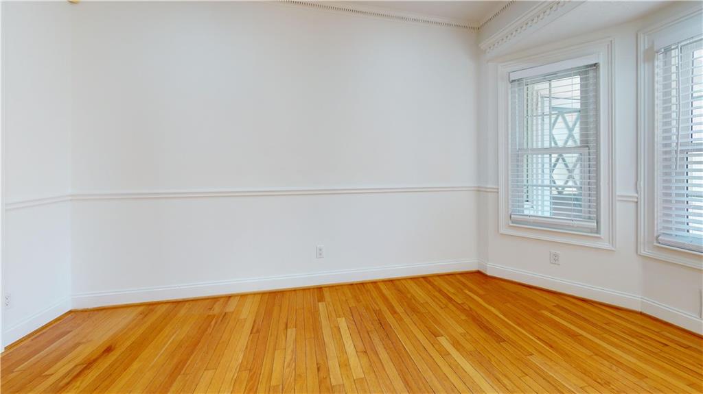 1319 Janmar Road Snellville, GA 30078 - Photo 32 of 38 an empty room with wooden floor and windows