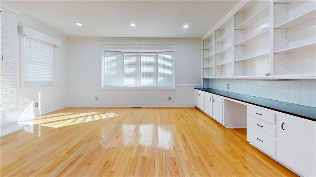 1319 Janmar Road Snellville, GA 30078 - Photo 35 of 38 a view of an empty room with wooden floor and cabinets