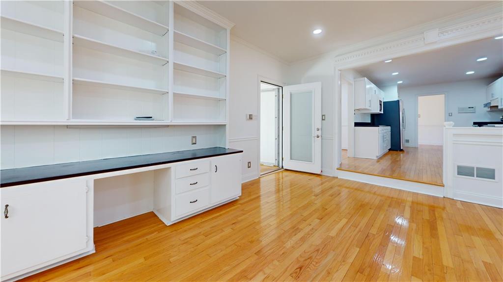 1319 Janmar Road Snellville, GA 30078 - Photo 6 of 38 a kitchen with granite countertop white cabinets and wooden floors