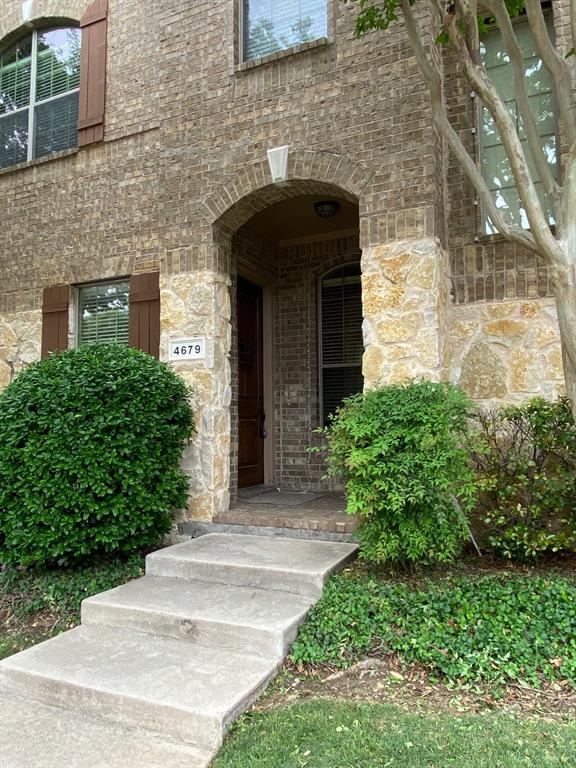 4679 Edith Street Plano, TX 75024 - Photo 4 of 34 Brick and stone facade featuring a prominent arched entryway
