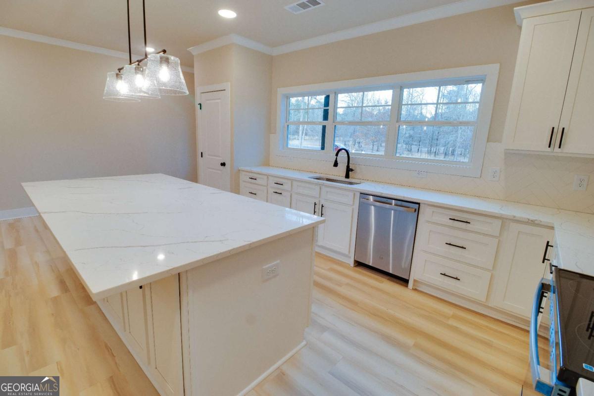 1021 Pointe Street South Tignall, GA 30668 - Photo 12 of 48 a kitchen with cabinets a sink dishwasher a stove and a refrigerator with wooden floor
