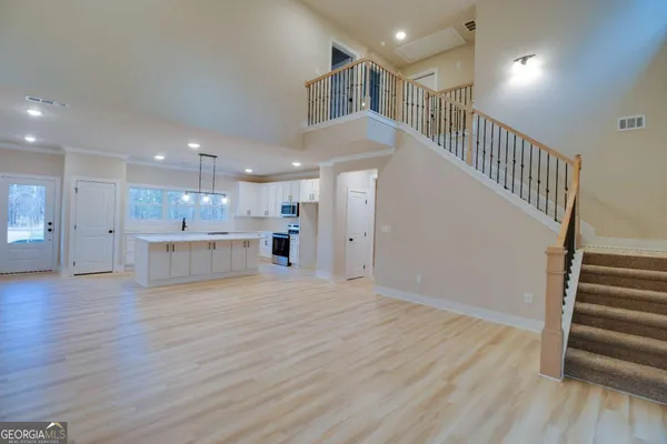 a view of kitchen and hall with wooden floor