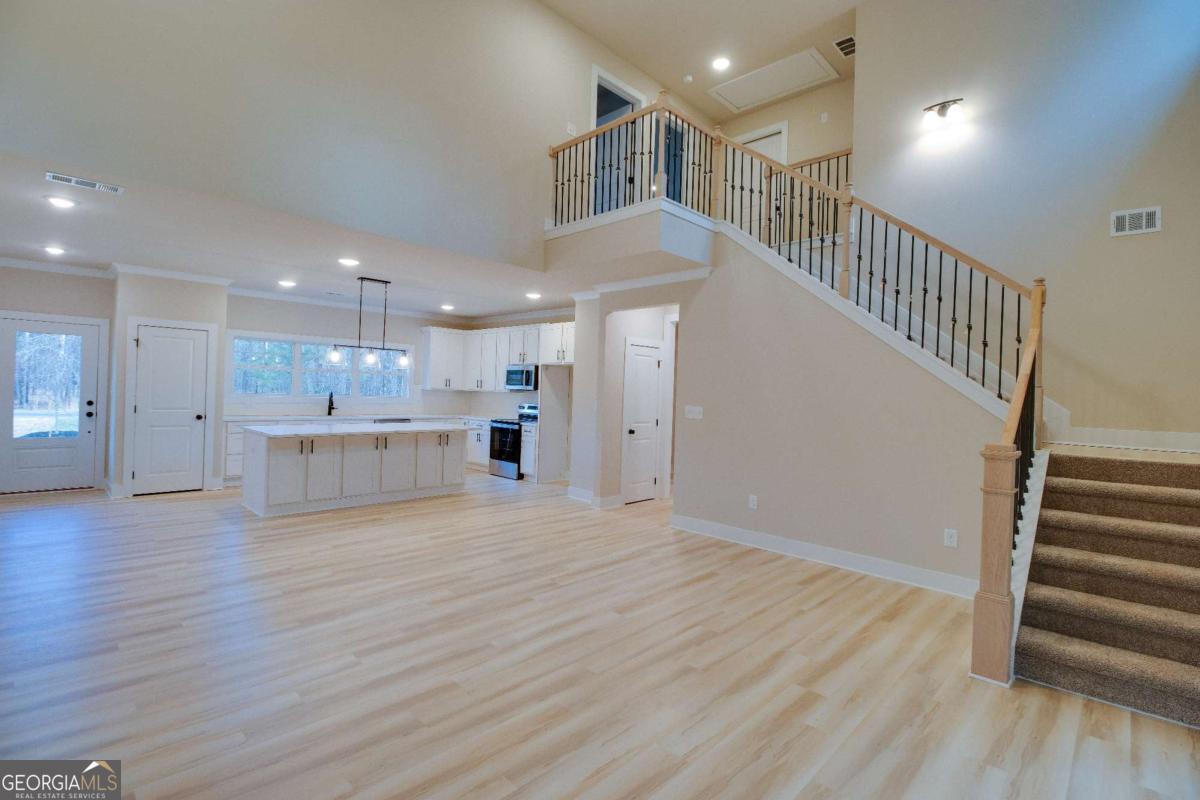 1021 Pointe Street South Tignall, GA 30668 - Photo 13 of 48 a view of kitchen and hall with wooden floor