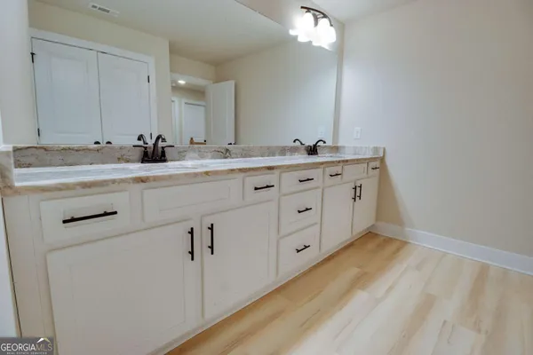 a bathroom with a double vanity sink and mirror