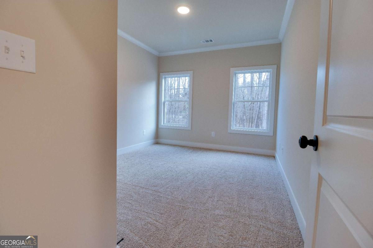 1021 Pointe Street South Tignall, GA 30668 - Photo 21 of 48 a view of an empty room with a window