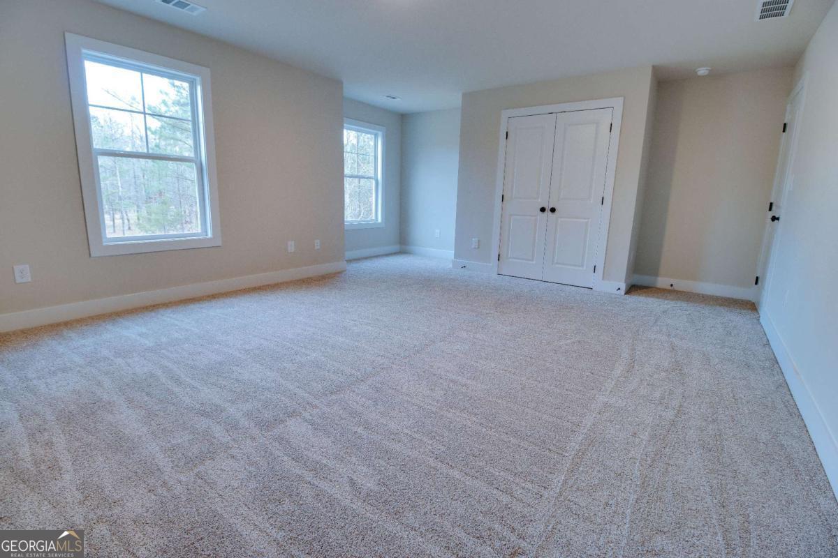 1021 Pointe Street South Tignall, GA 30668 - Photo 22 of 48 an empty room with windows