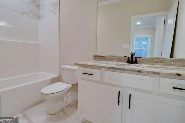 a bathroom with a sink toilet vanity and tub