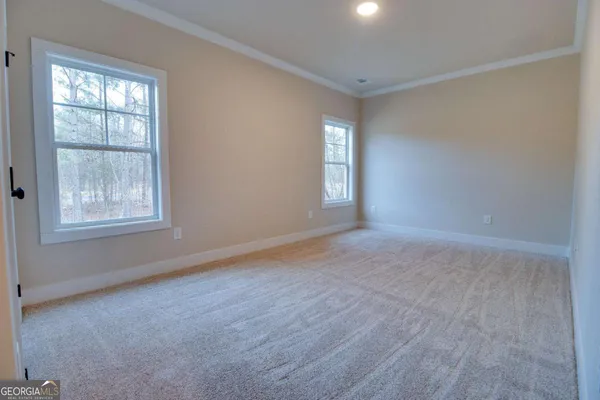 an empty room with windows and closet