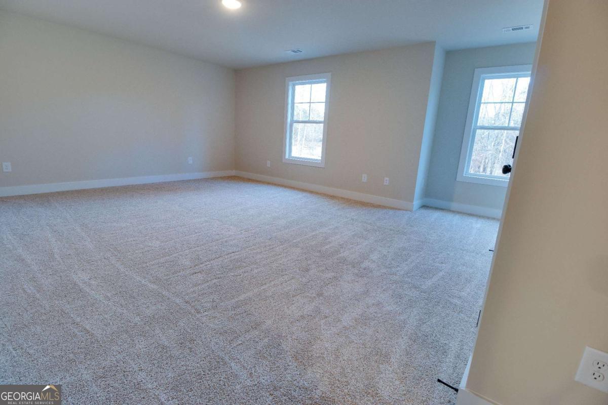 1021 Pointe Street South Tignall, GA 30668 - Photo 29 of 48 an empty room with windows and closet