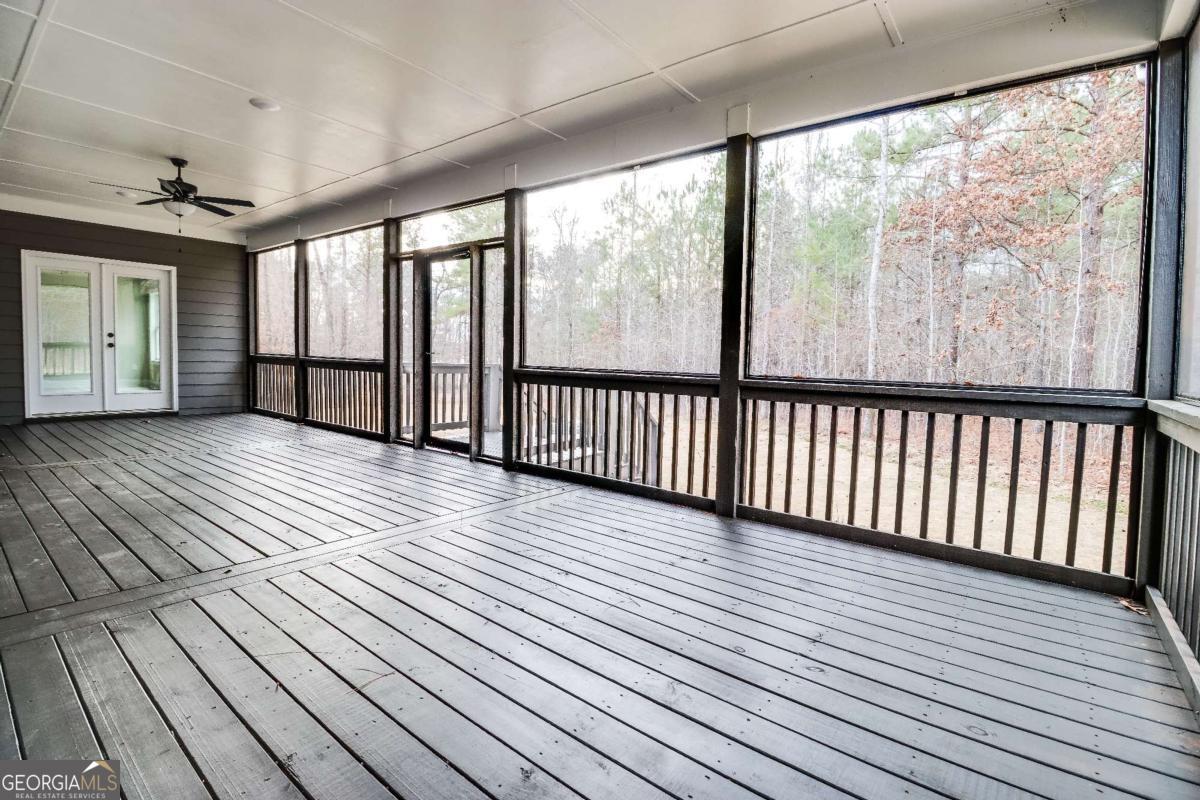 1021 Pointe Street South Tignall, GA 30668 - Photo 37 of 48 a view of a room with wooden floor and large windows