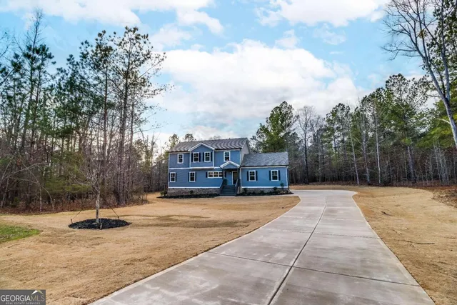 a view of a house with snow on the road