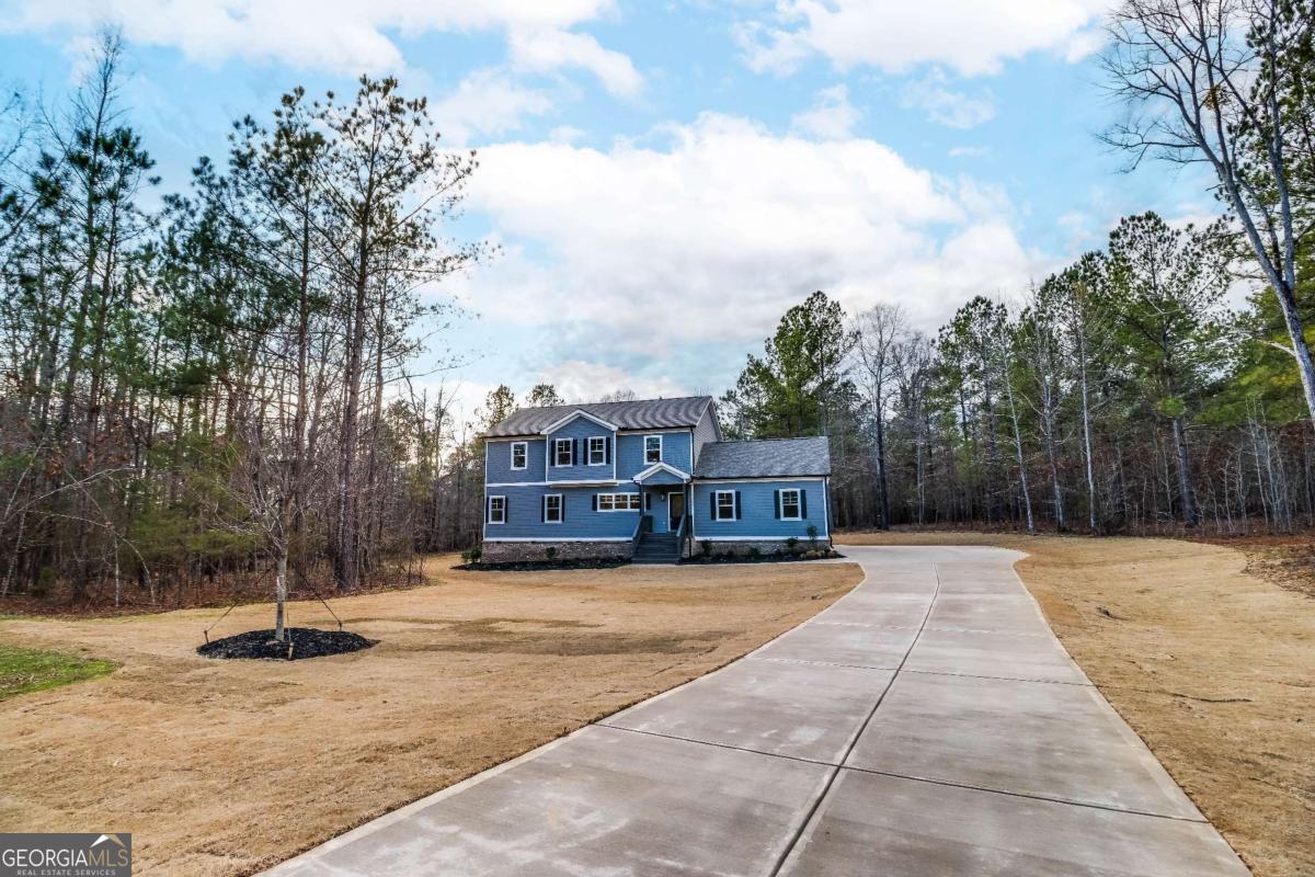 1021 Pointe Street South Tignall, GA 30668 - Photo 4 of 48 a view of a house with snow on the road