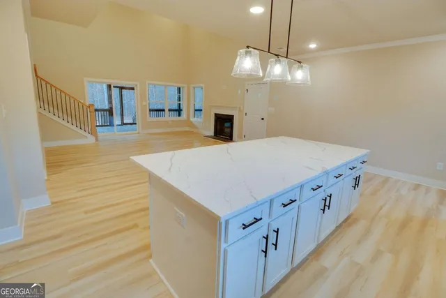 a kitchen with cabinets a sink dishwasher a stove and a refrigerator with wooden floor