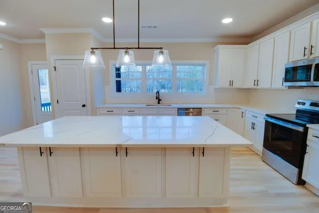 a view of kitchen and hall with wooden floor