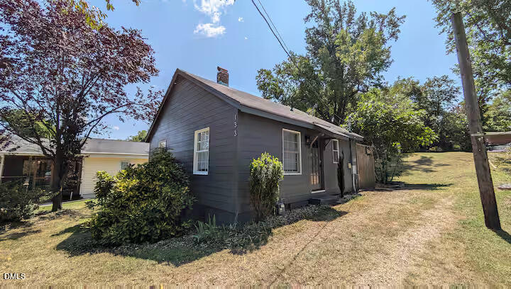 a view of a house with a yard covered in snow