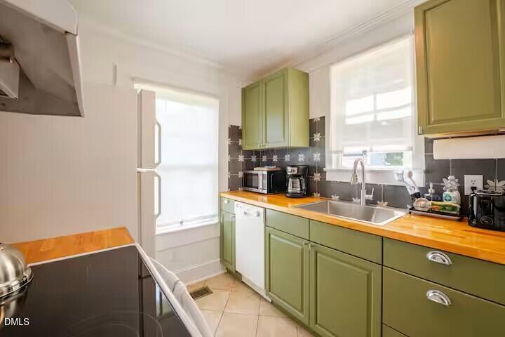 133 Prospect Avenue Raleigh, NC 27603 - Photo 4 of 7 a kitchen with sink a refrigerator and window