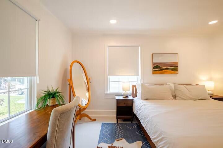 133 Prospect Avenue Raleigh, NC 27603 - Photo 5 of 7 a bedroom with a bed a couch and a potted plant