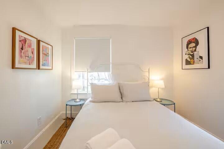 133 Prospect Avenue Raleigh, NC 27603 - Photo 6 of 7 a bedroom with a bed and a window