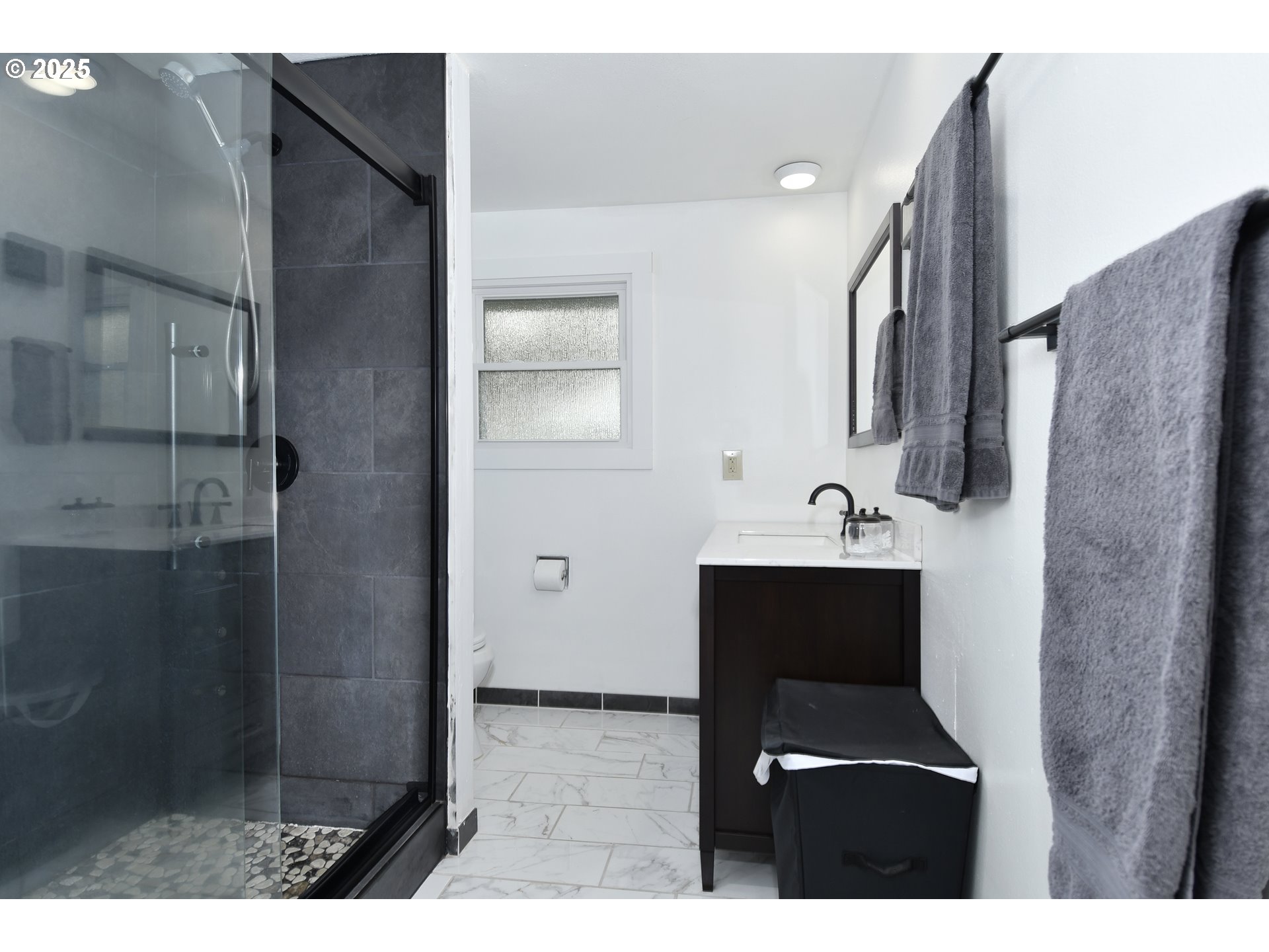 1889 Northeast Beech Avenue Gresham, OR 97030 - Photo 9 of 27 a bathroom with a sink a mirror and shower