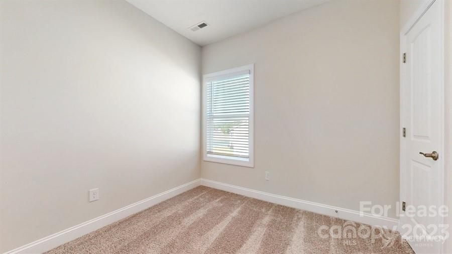 163 Tanner Loop Troutman, NC 28166 - Photo 14 of 27 a view of an empty room and window