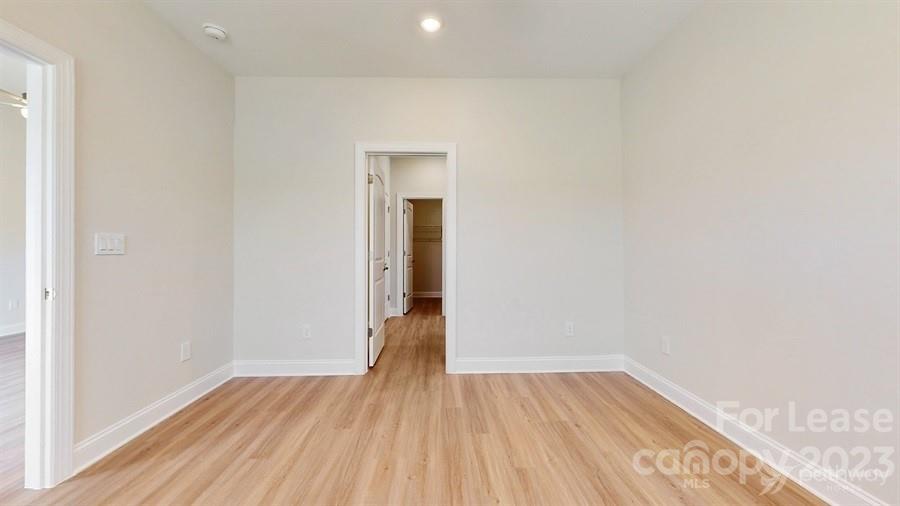 163 Tanner Loop Troutman, NC 28166 - Photo 19 of 27 a view of a room with wooden floor and a window