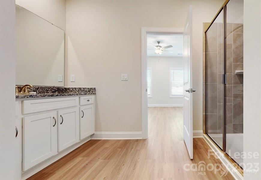 163 Tanner Loop Troutman, NC 28166 - Photo 21 of 27 a view of kitchen with granite countertop cabinets and wooden floor